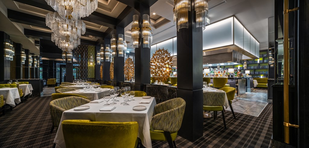 a dining room with tables and chairs and a bar