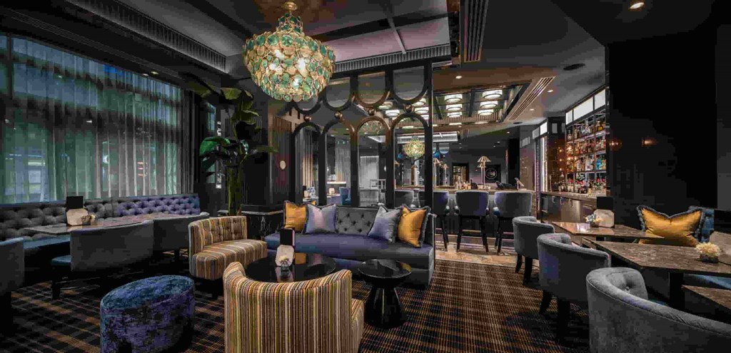 the interior of a restaurant with couches chairs and tables and a large window