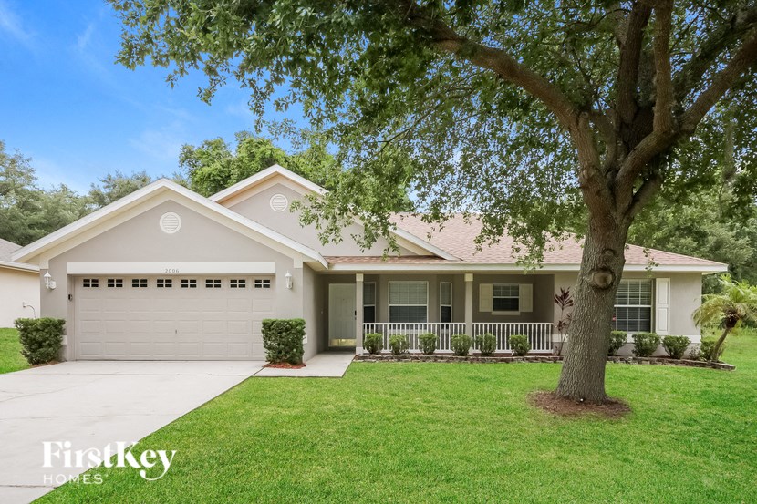 A house with a tree in front of it.