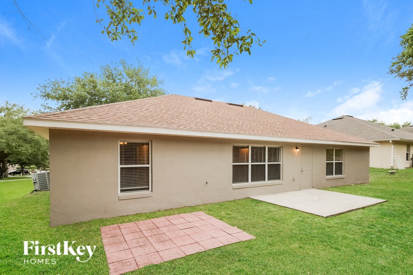 A house with a brown roof and a beige exterior is for sale.
