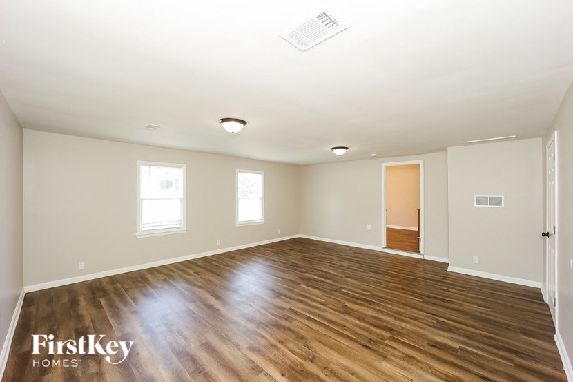 the living room and dining room with hardwood flooring