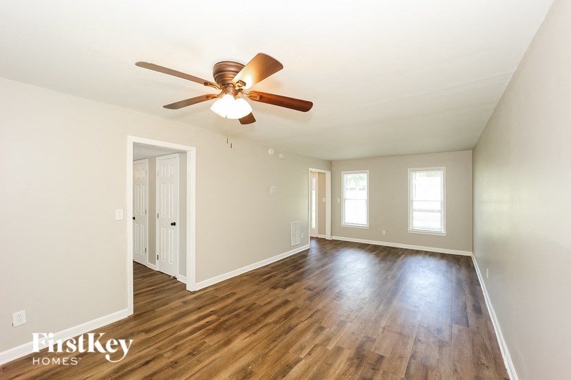 a living room with hardwood floors and a ceiling fan
