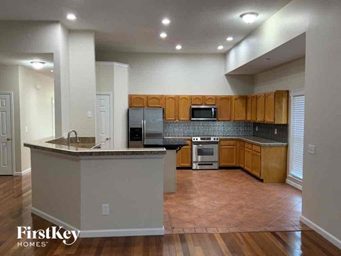 an empty kitchen with wooden cabinets and a counter top