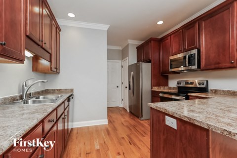 a kitchen with wood cabinets and granite counter tops and a sink