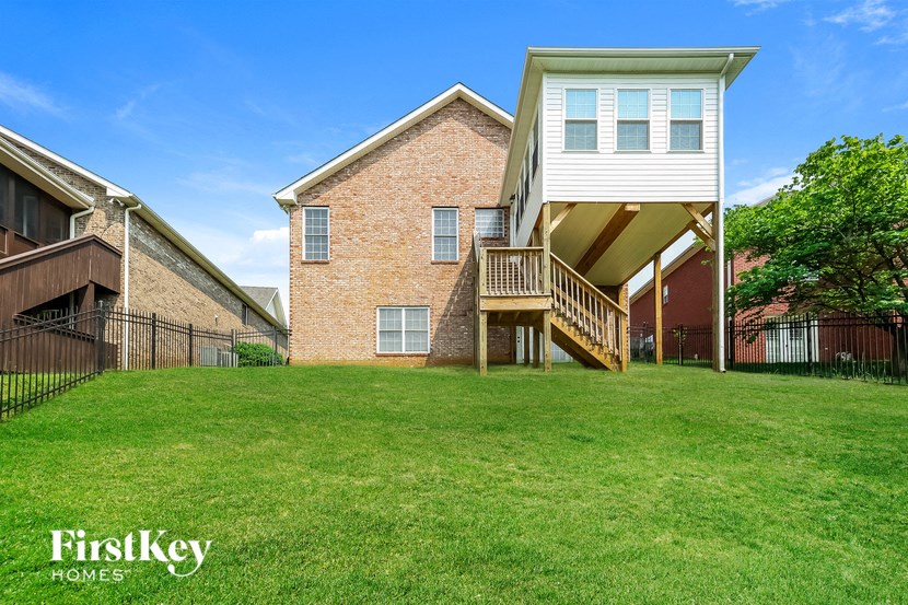 a brick house with a deck on the side of it