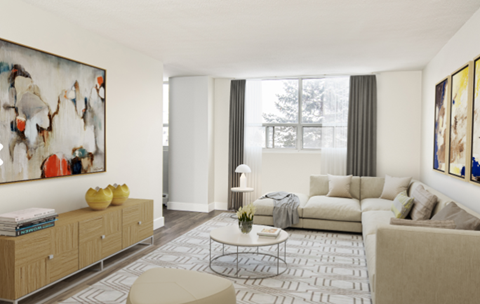A living room with a large painting on the wall and a white sofa.