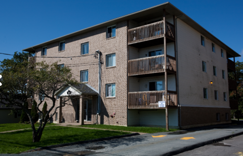 A large apartment building with a balcony on the second floor.