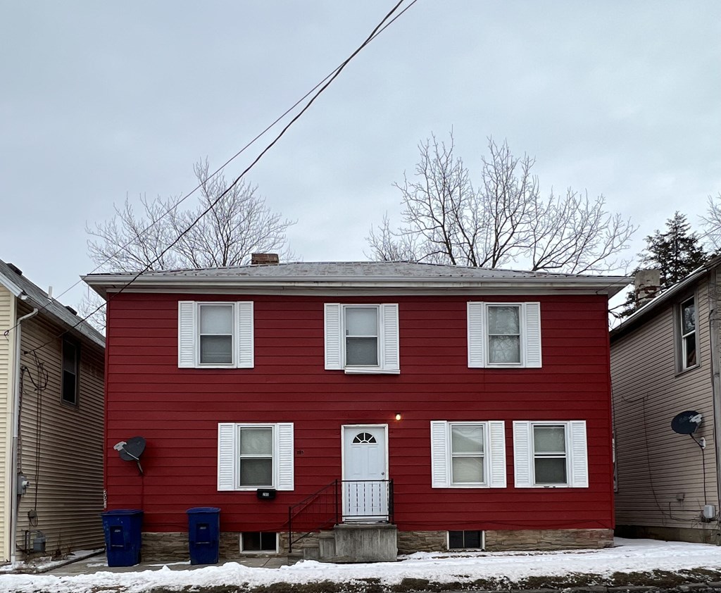 a red house with white windows and a white door