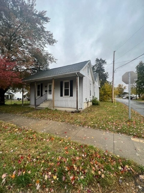 a small white house on the side of a street