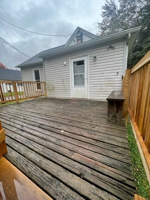 a backyard deck with a house in the background