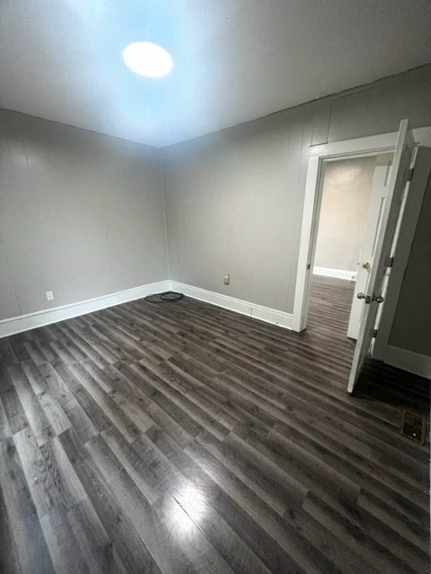 a empty room with wooden floors and a door