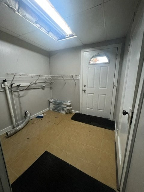 a bathroom with a white door and a tile floor