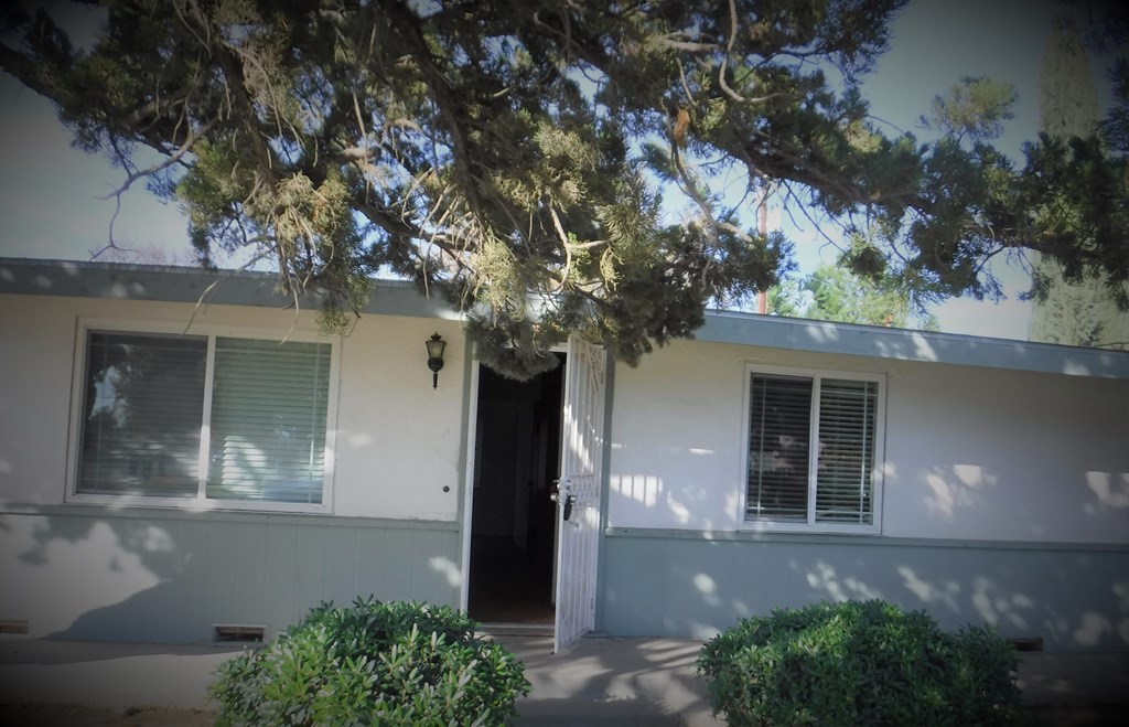 the front of the house with the door open