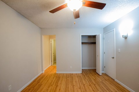 A room with a ceiling fan and light fixture.