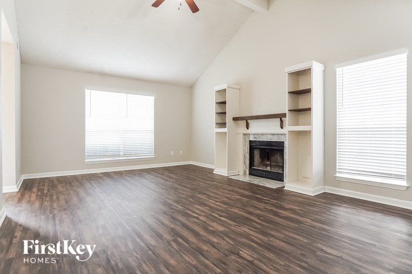 the living room with wood flooring and a fireplace