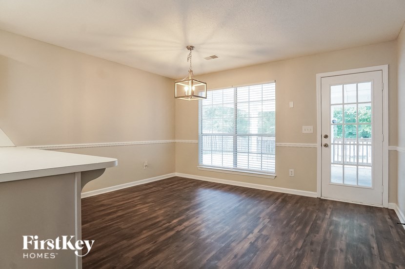 an empty living room with a window and a door to a patio