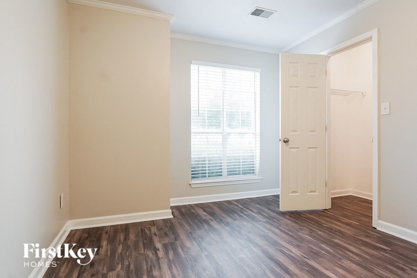 a living room with wood floors and a white door