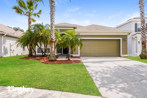 a house with palm trees in front of it