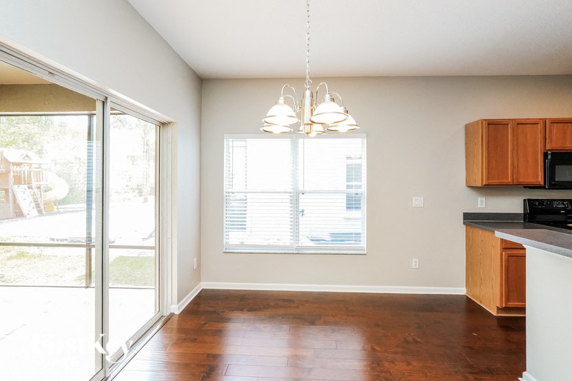 a kitchen with a large window and a sliding glass door
