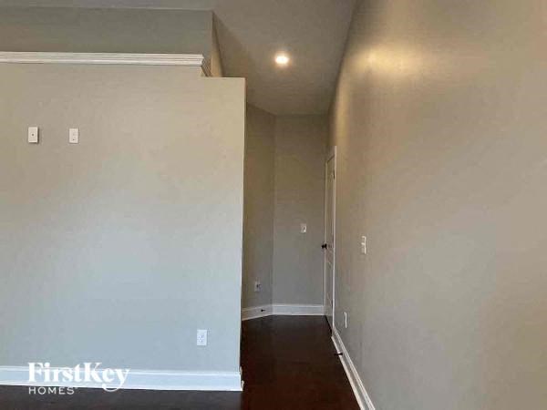 an empty room with a hallway and a door