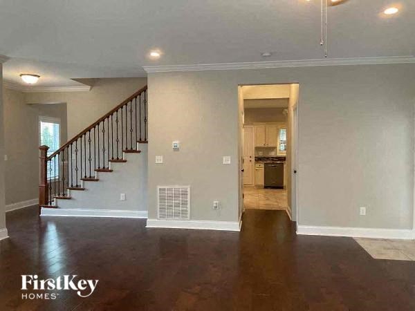 an empty living room with a staircase in a house