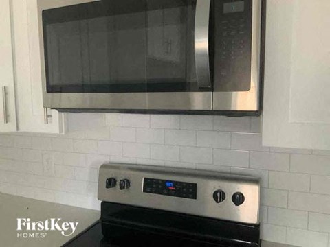 a kitchen with a microwave and a stove