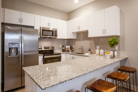 a kitchen with granite counter tops and stainless steel appliances