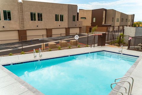 a swimming pool with a building in the background
