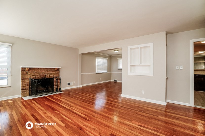 a living room with a fireplace and a wooden floor