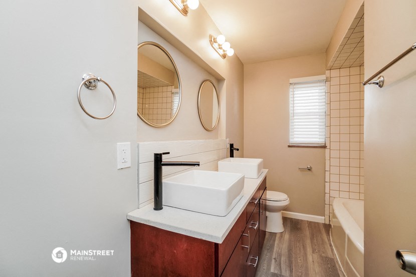 a bathroom with a sink and a toilet and a mirror
