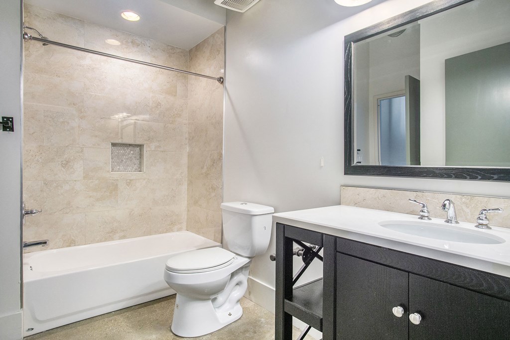 a bathroom with a sink toilet and a bath tub