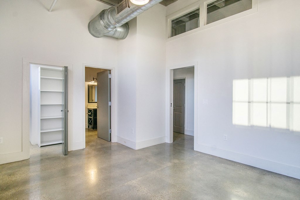 the interior of an empty room with white walls and a concrete floor