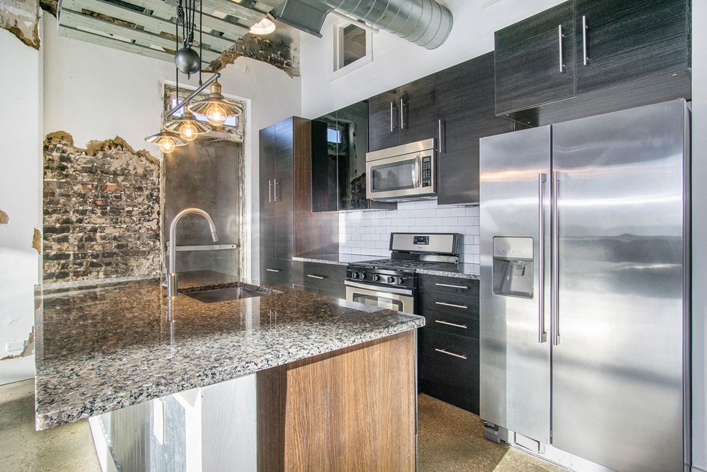 a kitchen with stainless steel appliances and granite counter tops
