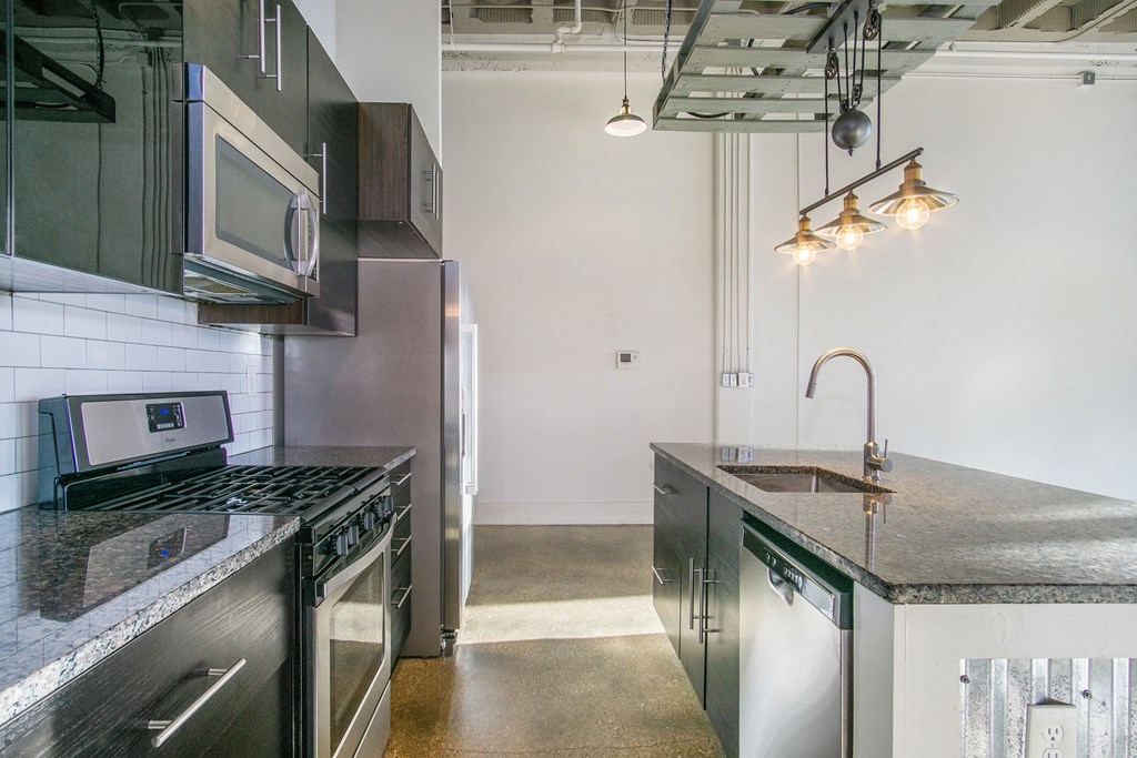a kitchen with stainless steel appliances and granite counter tops
