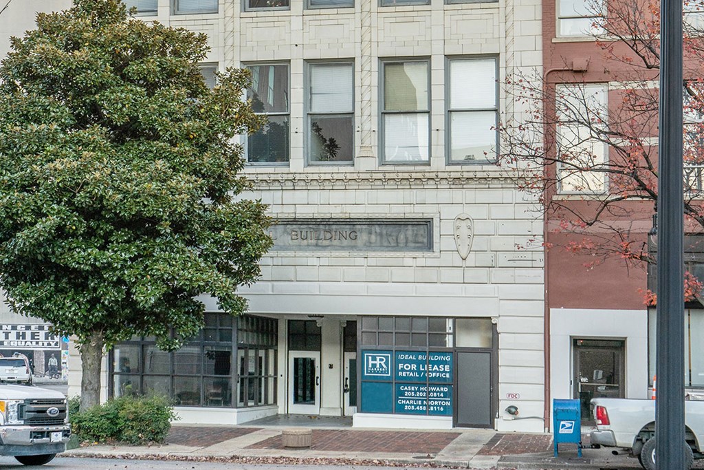 a city building with a tree in front of it