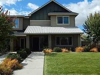 a house with a sidewalk in front of it