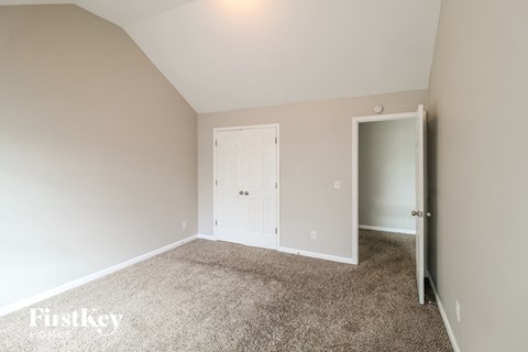 a bedroom with carpet and a white door