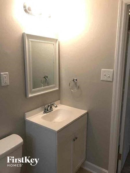 a white bathroom with a sink and a mirror
