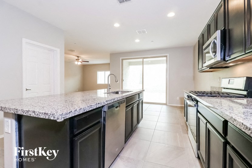 a kitchen with granite counter tops and stainless steel appliances