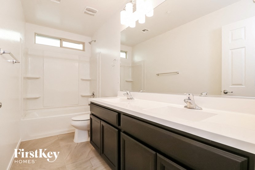 a bathroom with a sink and a toilet and a bath tub