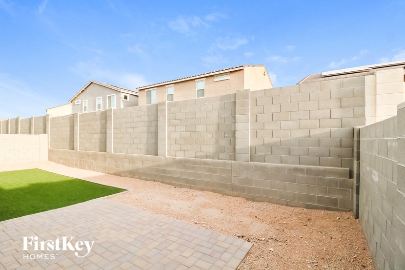 a retaining wall with a house behind it