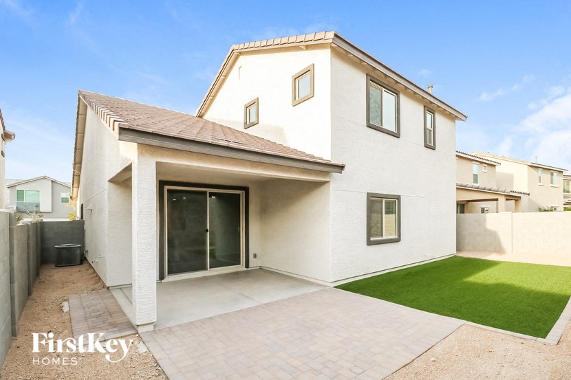 a white house with a driveway and grass