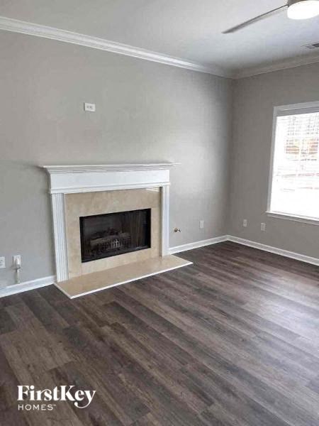 a living room with a fireplace and wooden floors