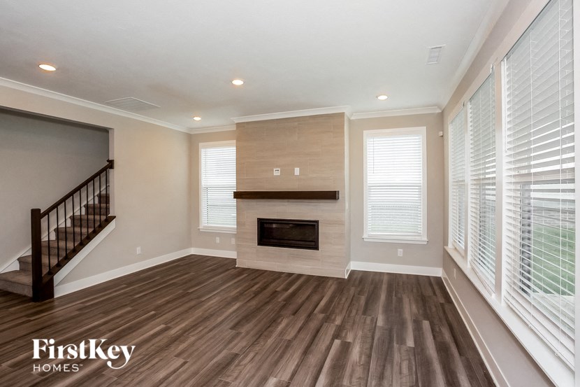 a living room with a fireplace and a staircase