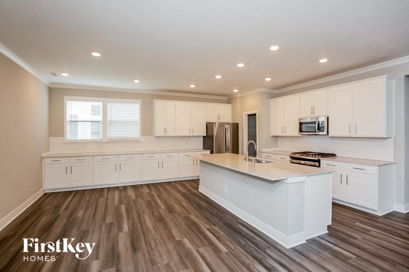 a large kitchen with white cabinets and a white counter top