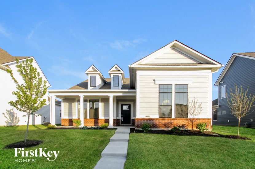 a white house with a lawn in front of it