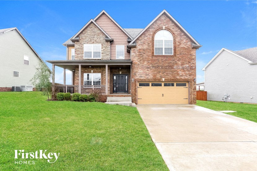 a large brick house with a yellow garage door
