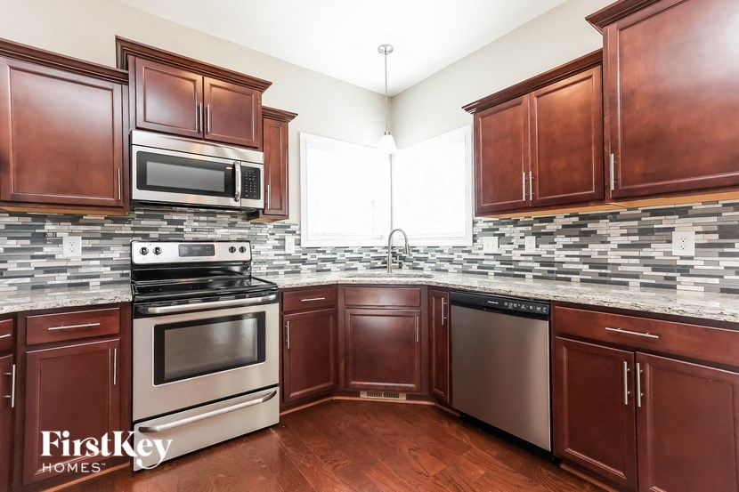 a kitchen with wood cabinets and stainless steel appliances