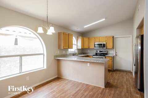 A kitchen with wooden cabinets and a large island.