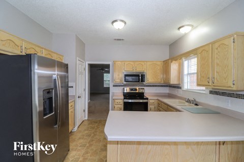 a kitchen with wooden cabinets and stainless steel appliances